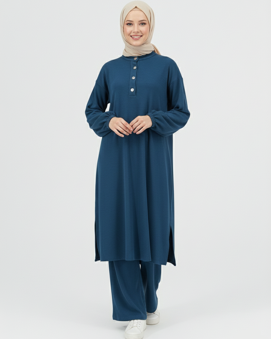 Woman wearing a blue ribbed matching set with a hijab on a white background