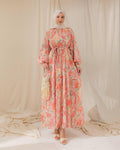 Woman wearing a floral dress with a plain background