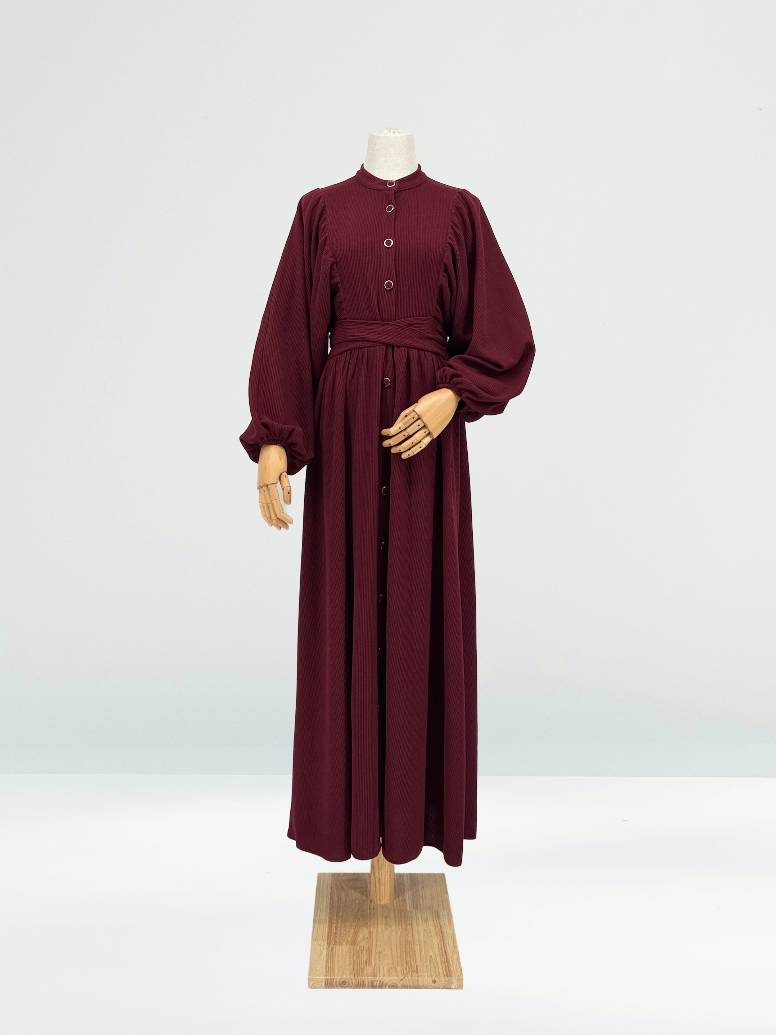 Maroon ribbed knit dress on a mannequin against a white background
