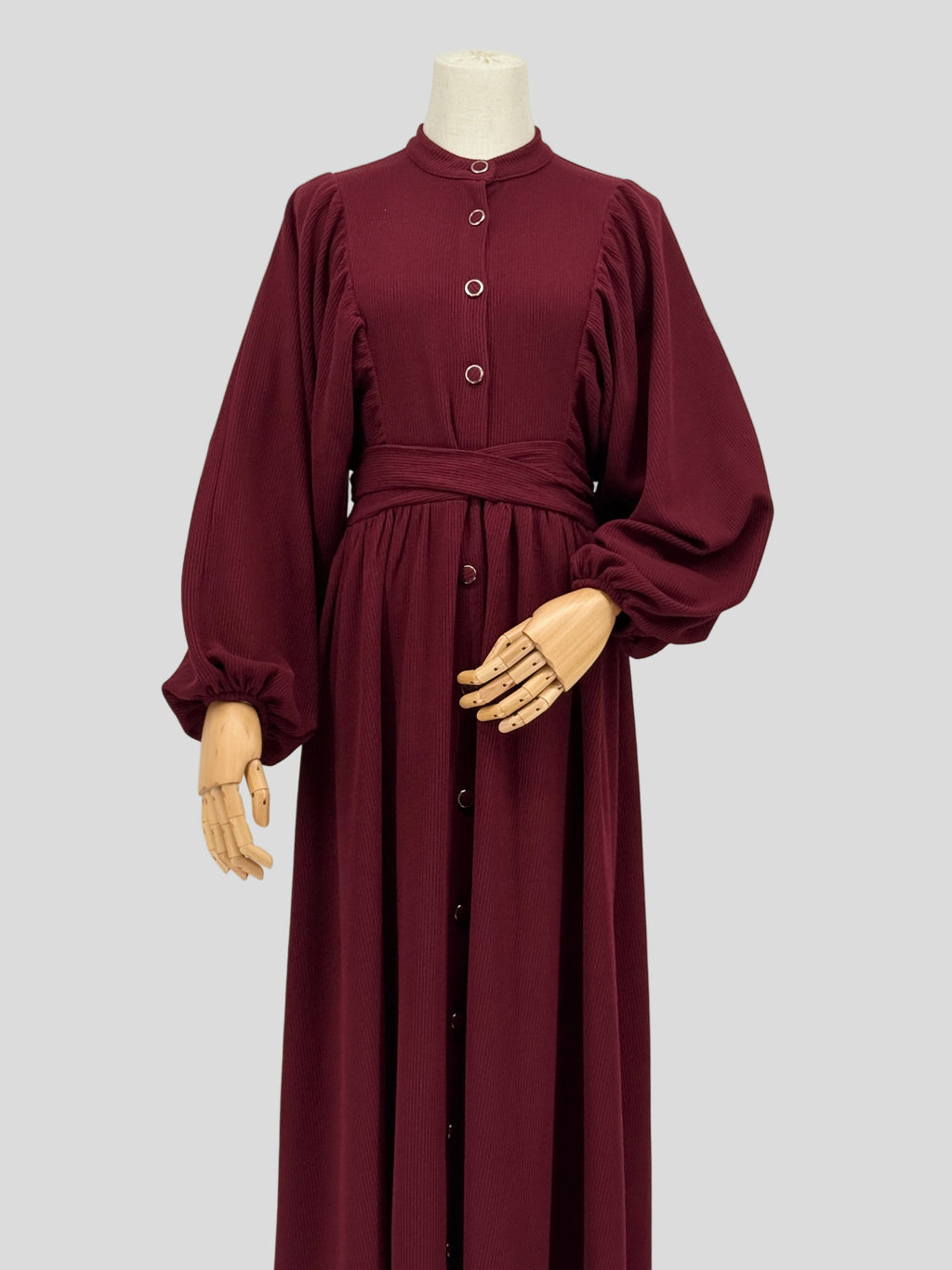 Maroon ribbed knit dress on a mannequin against a white background