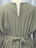Light green dress with a belt on a mannequin against a light background