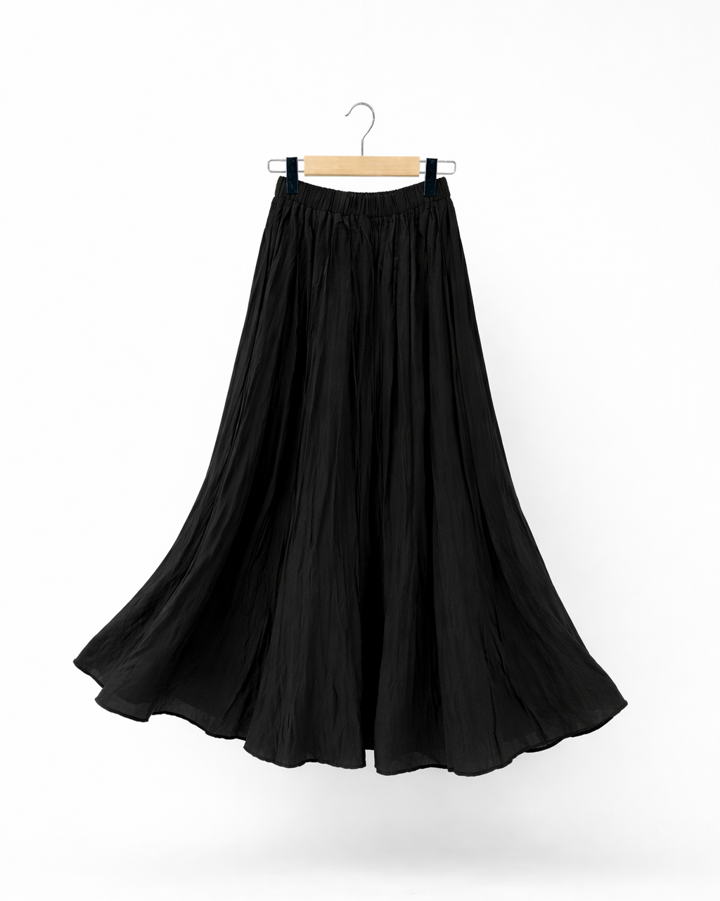 long black crinkle skirt on a hanger against a white background