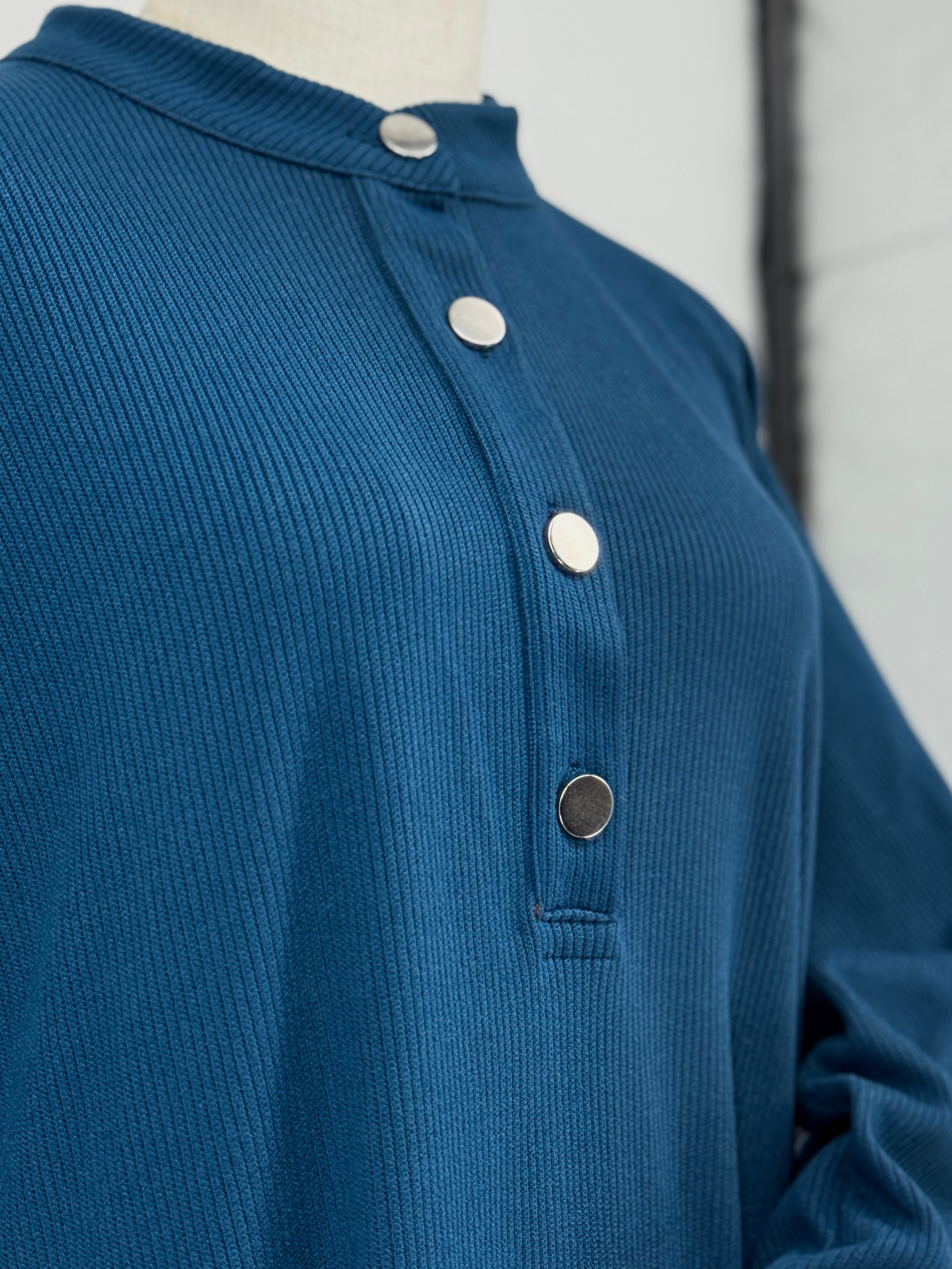 close-up of a blue ribbed matching set on a mannequin against a white background