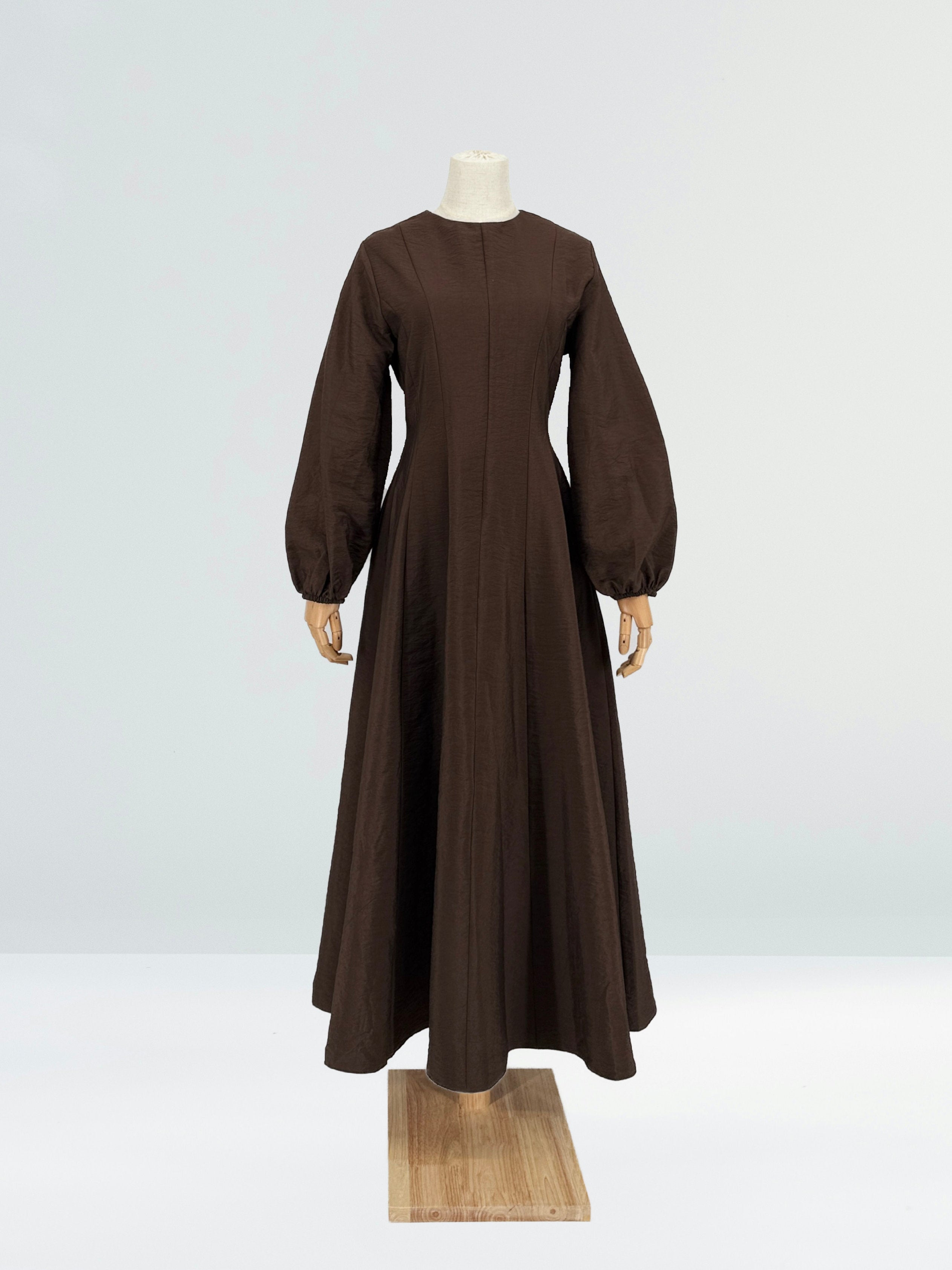 brown flare dress on a mannequin against a plain background