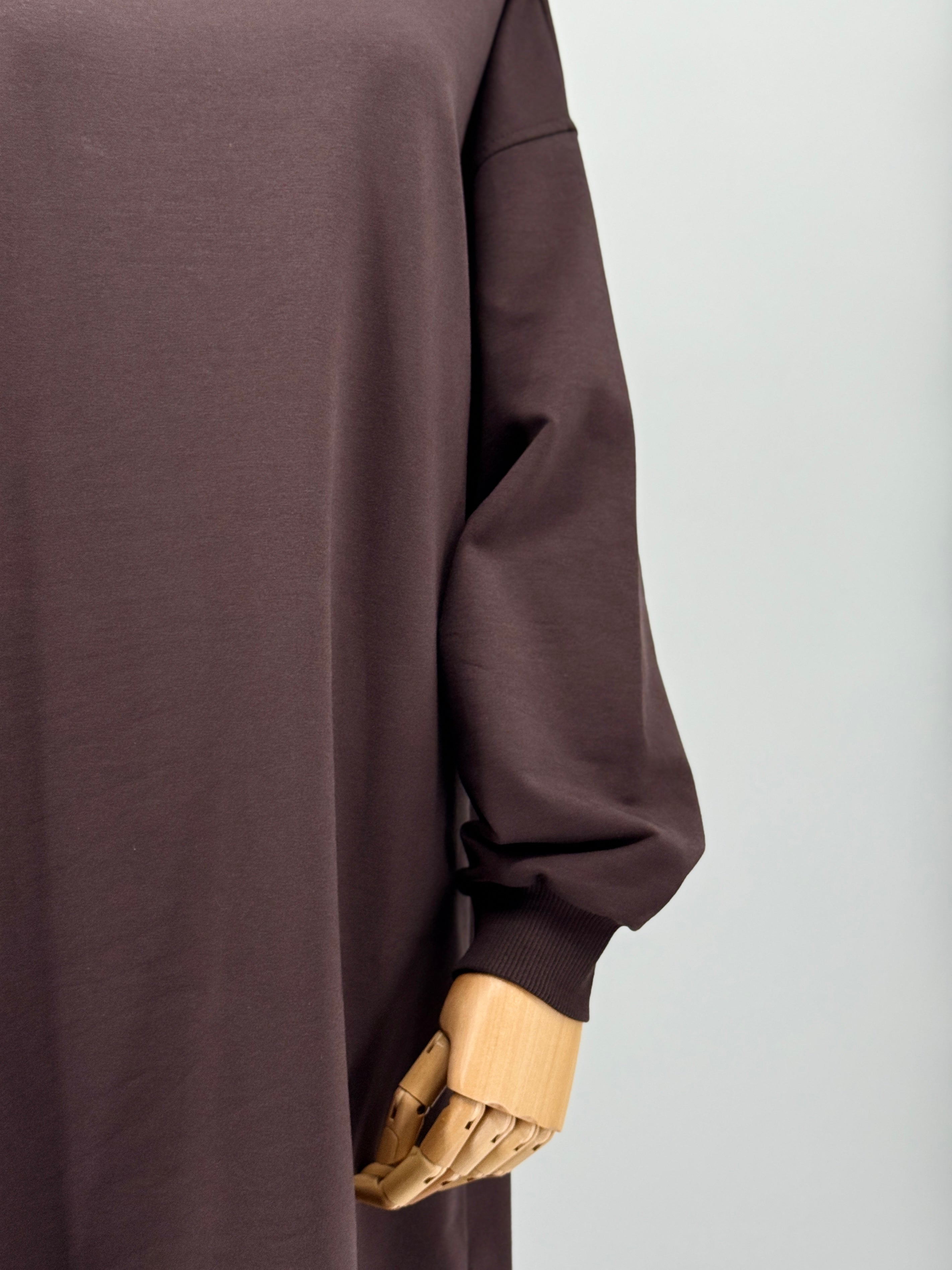 close-up of a brown long-sleeve tunic on a mannequin against a white background