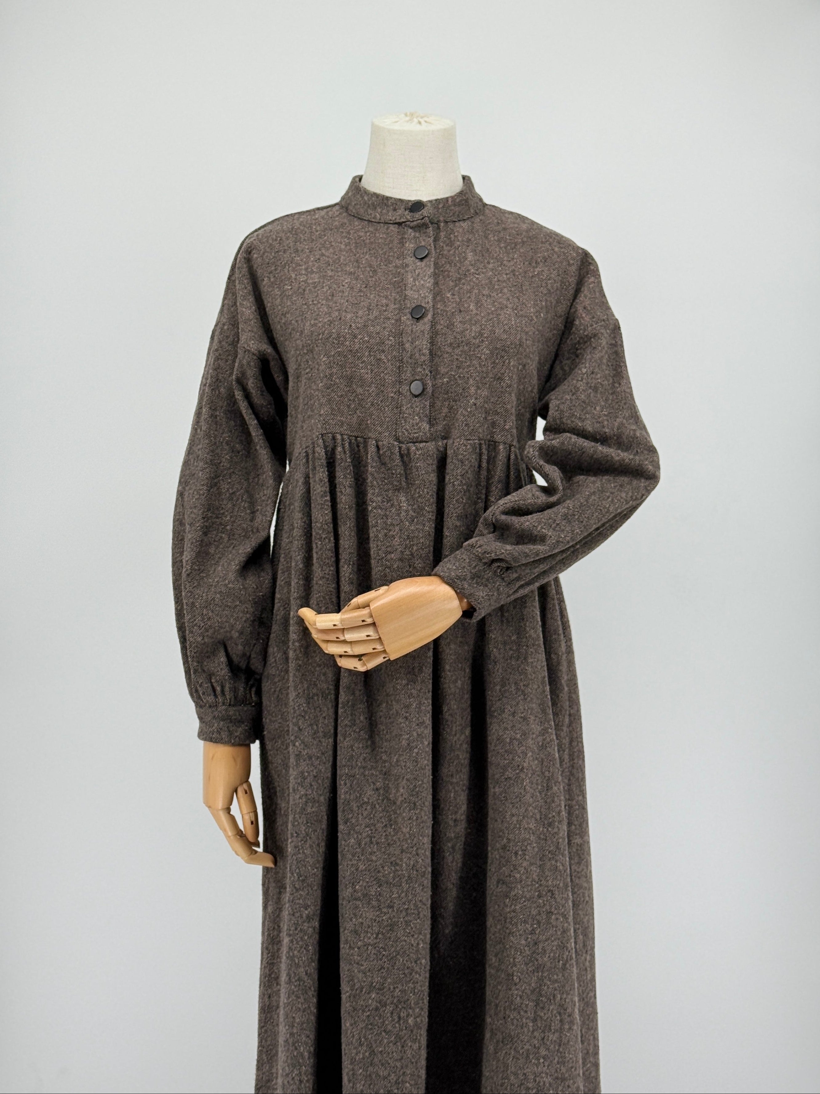brown long-sleeve dress on a mannequin against a white background
