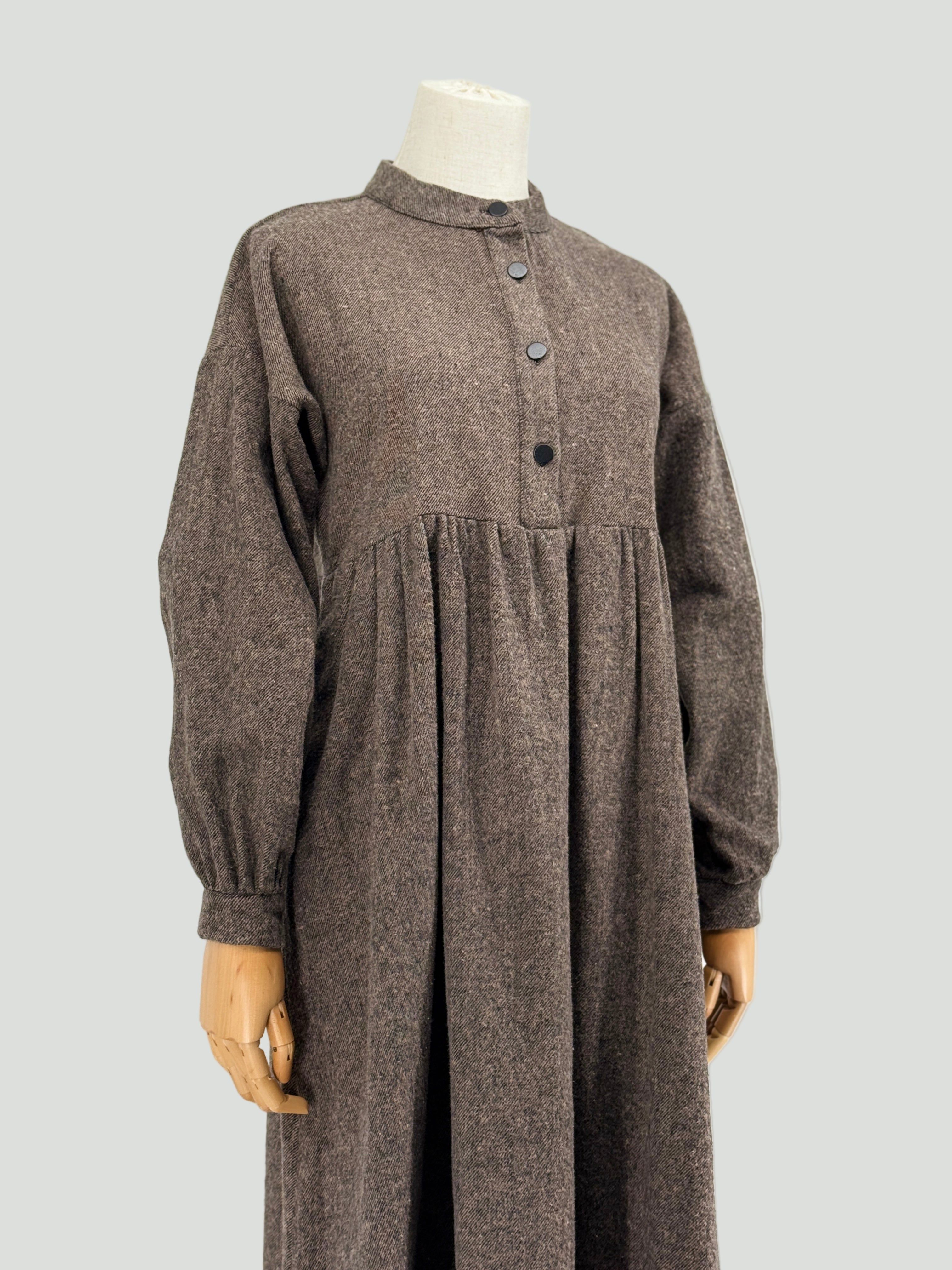 brown long-sleeve dress on a mannequin against a white background