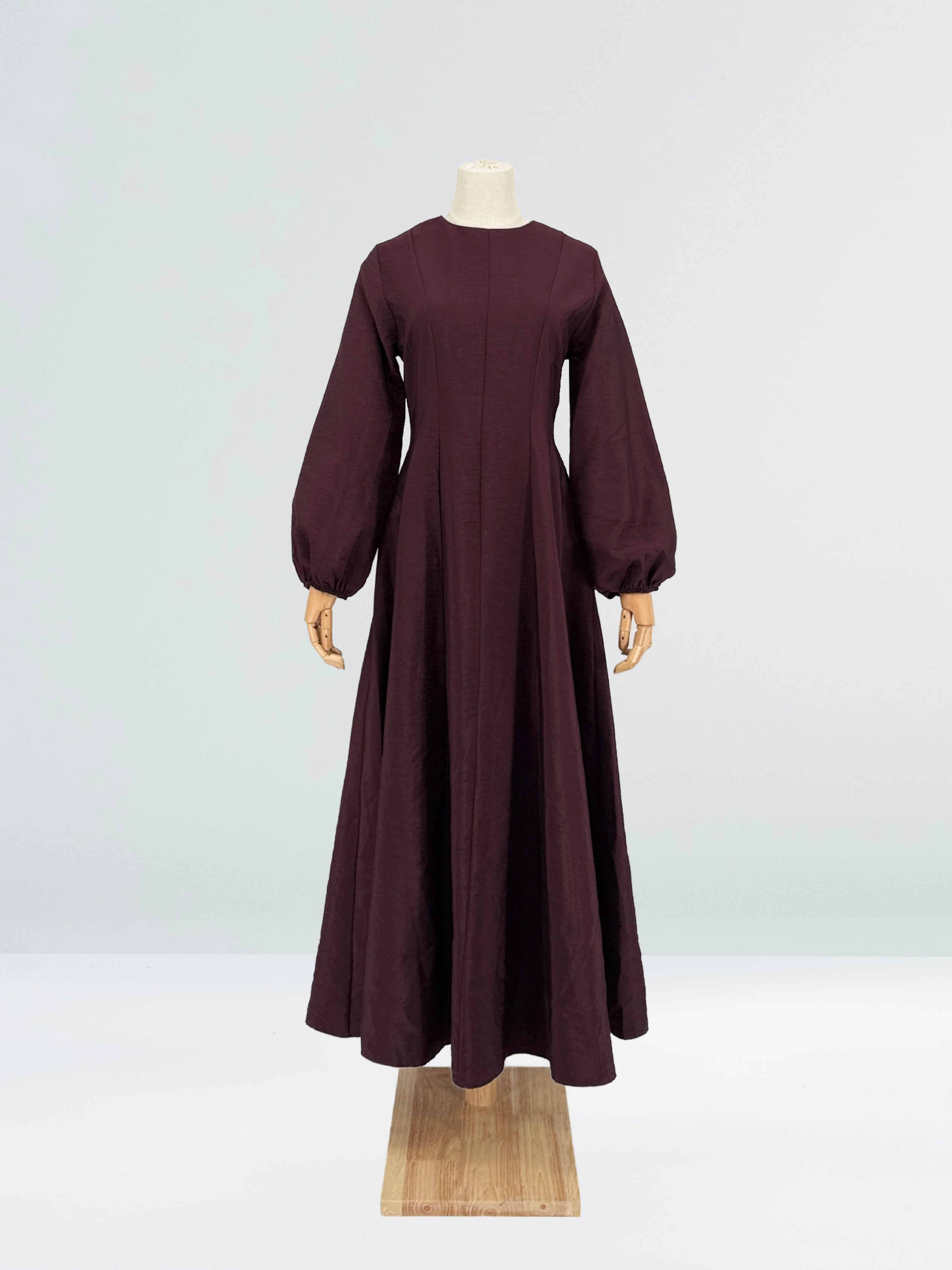 Burgundy flare dress on a mannequin against a plain background