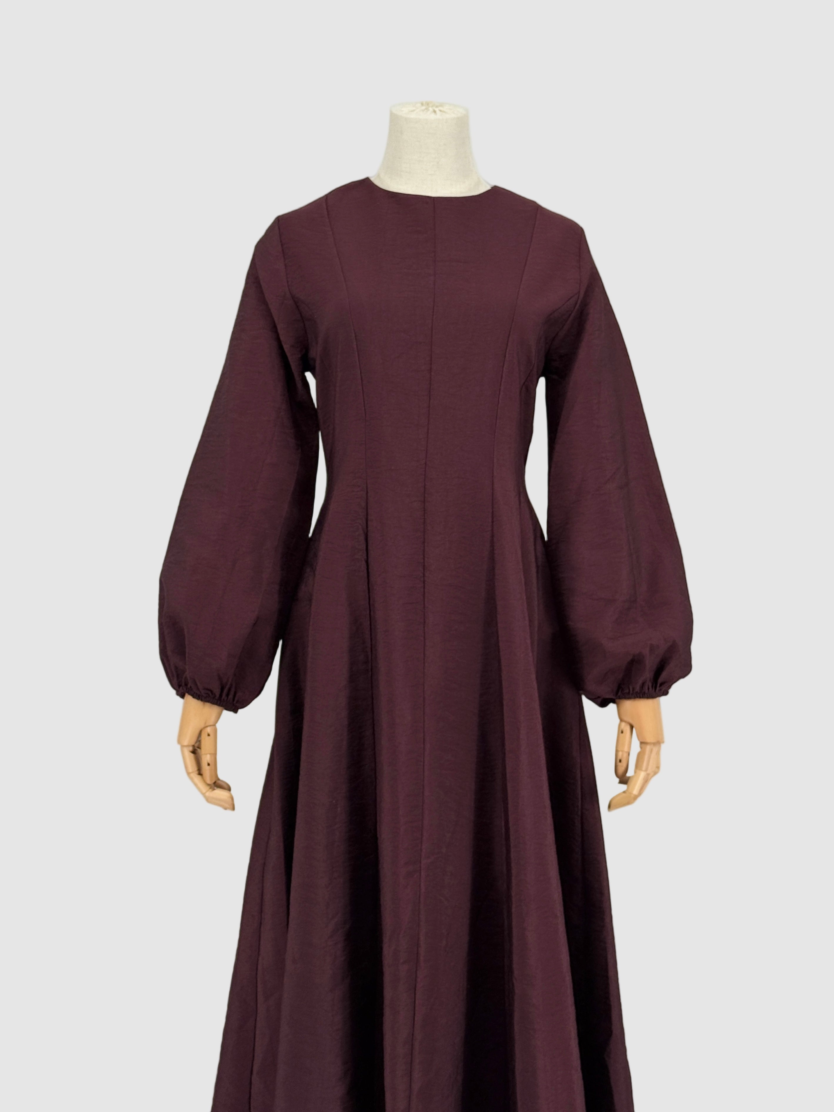 Burgundy flare dress on a mannequin against a plain background