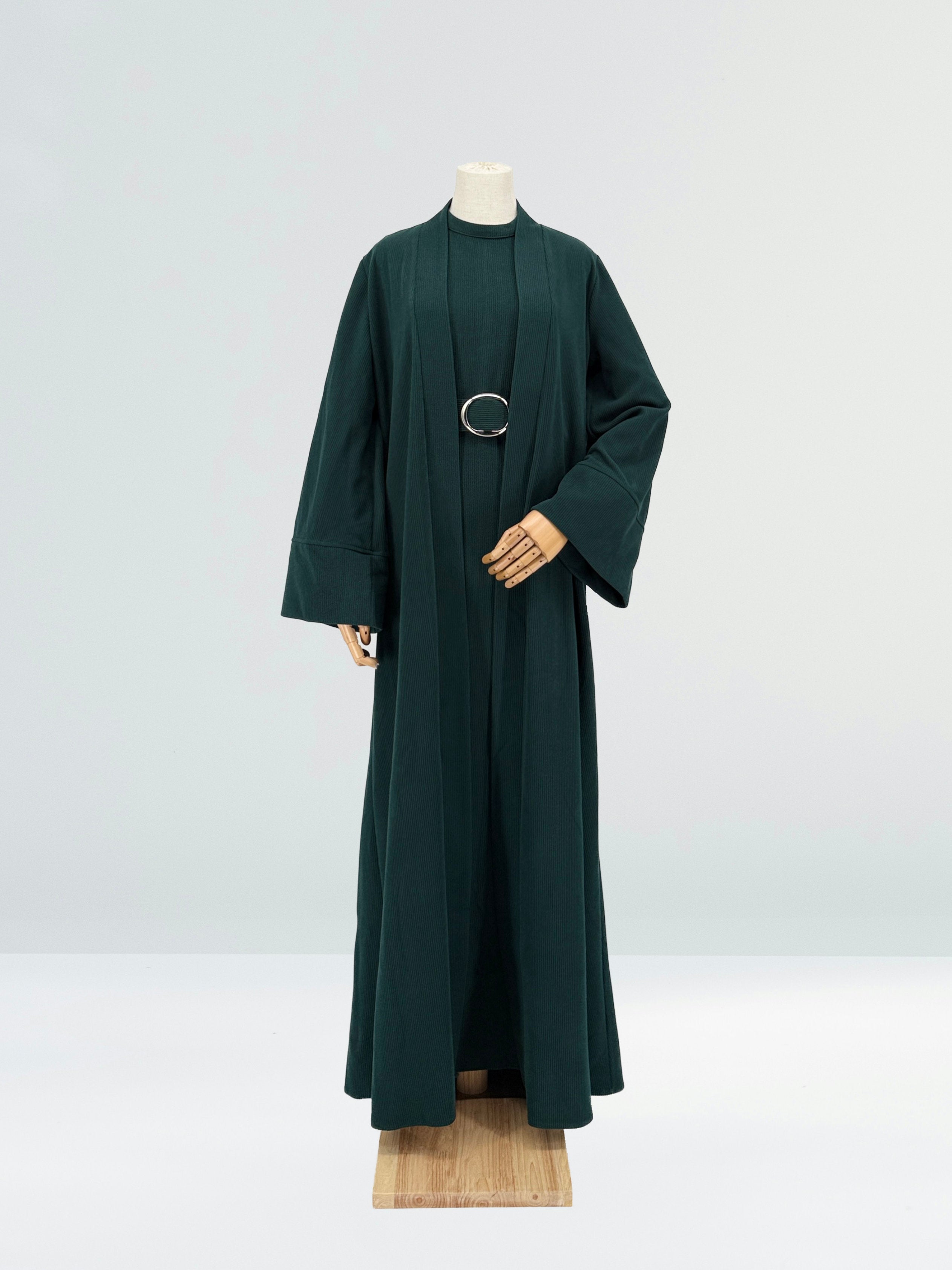 Dark green abaya on a mannequin against a white background