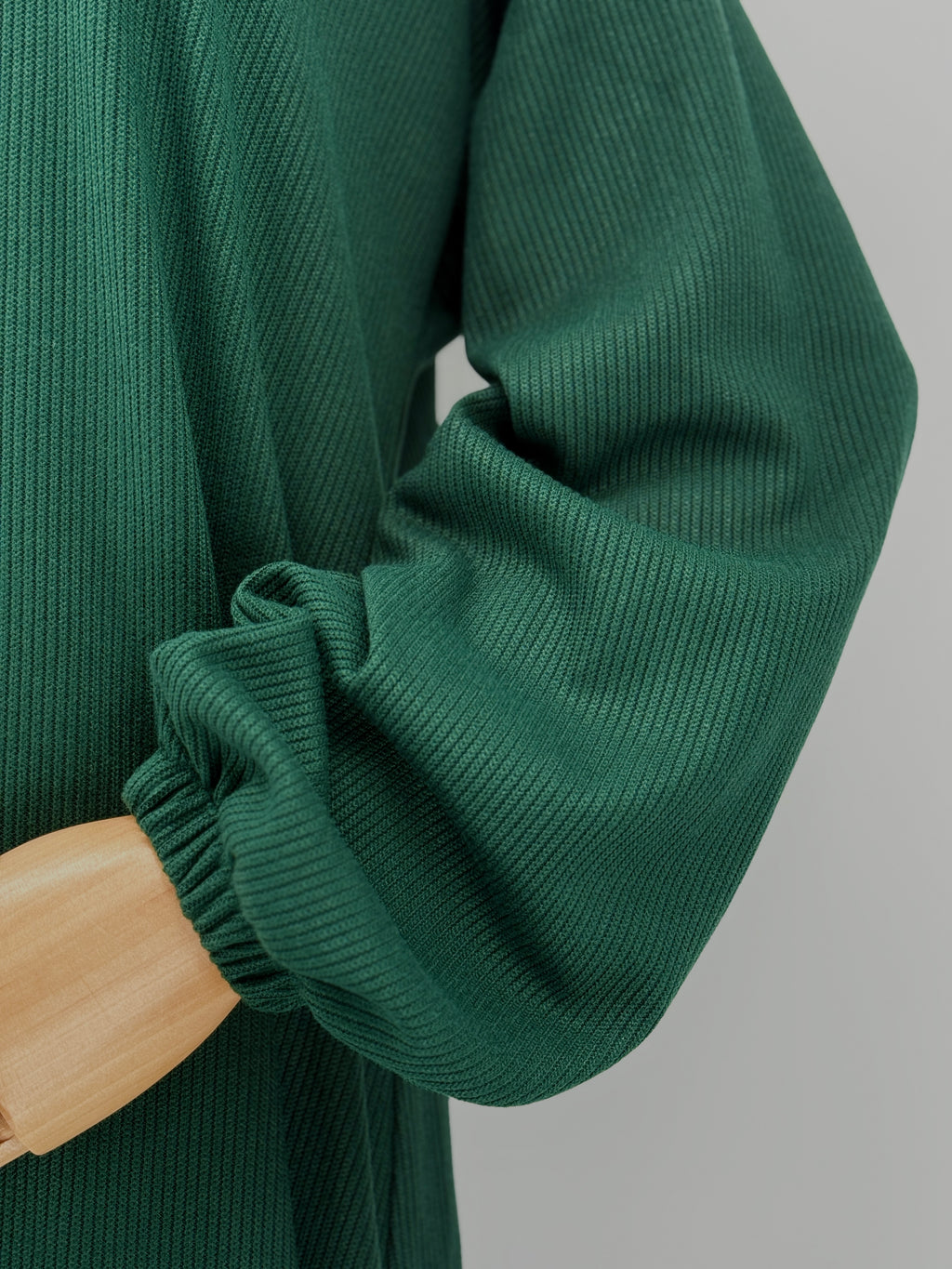 close-up on a green ribbed matching set on a mannequin against a white background