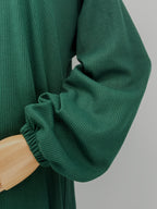 close-up on a green ribbed matching set on a mannequin against a white background