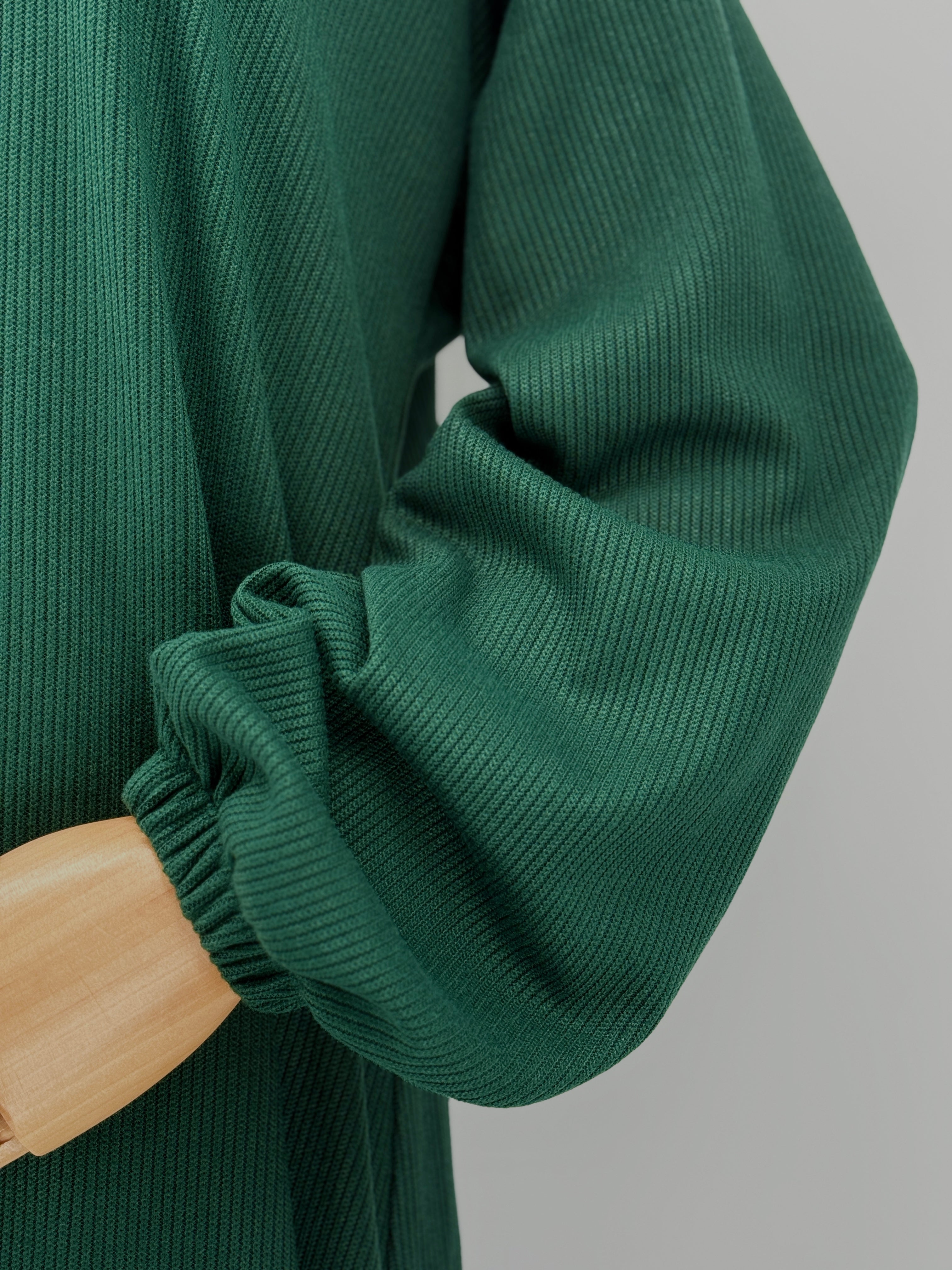 close-up on a green ribbed matching set on a mannequin against a white background