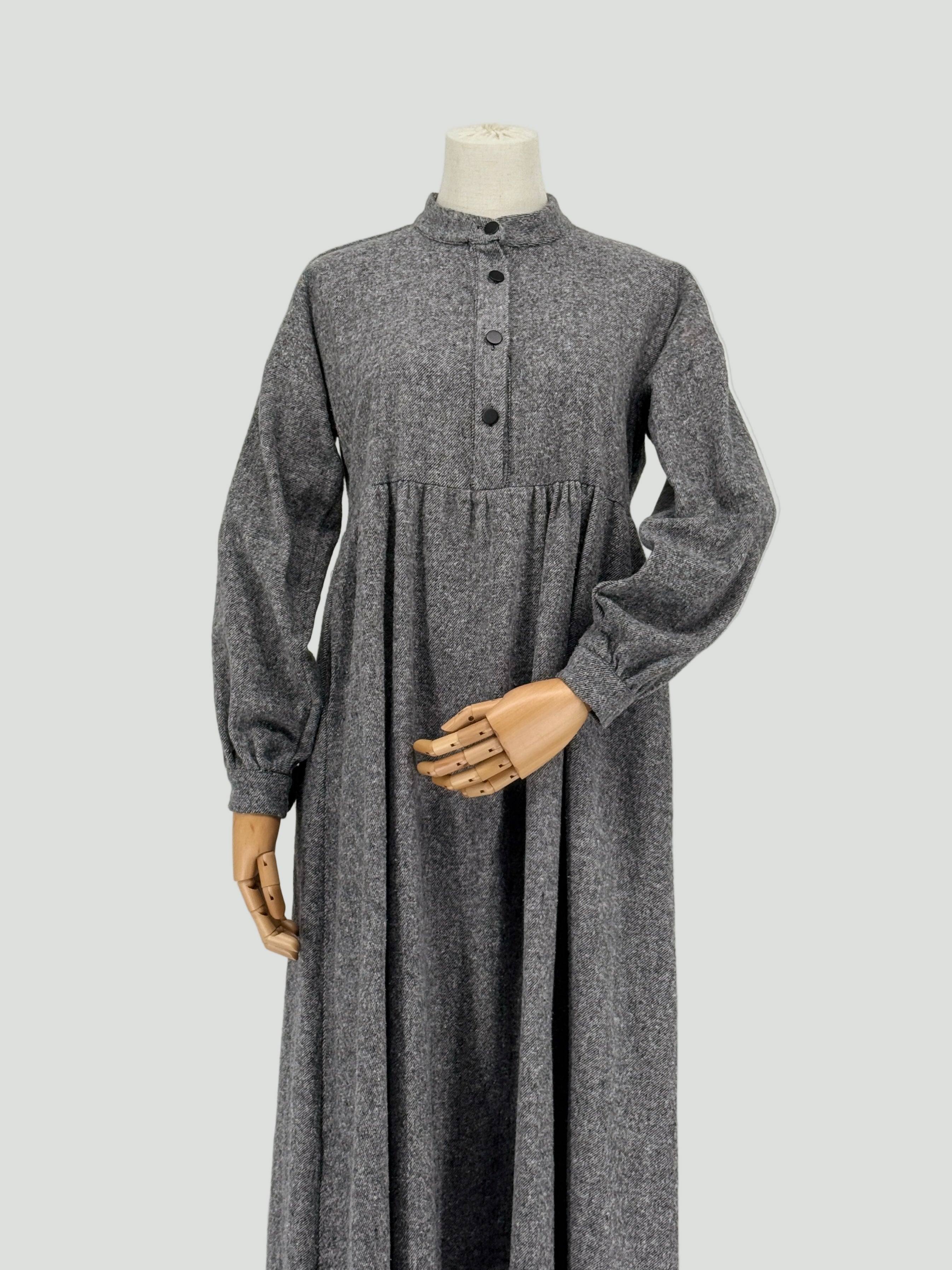 Gray long-sleeve dress on a mannequin against a white background