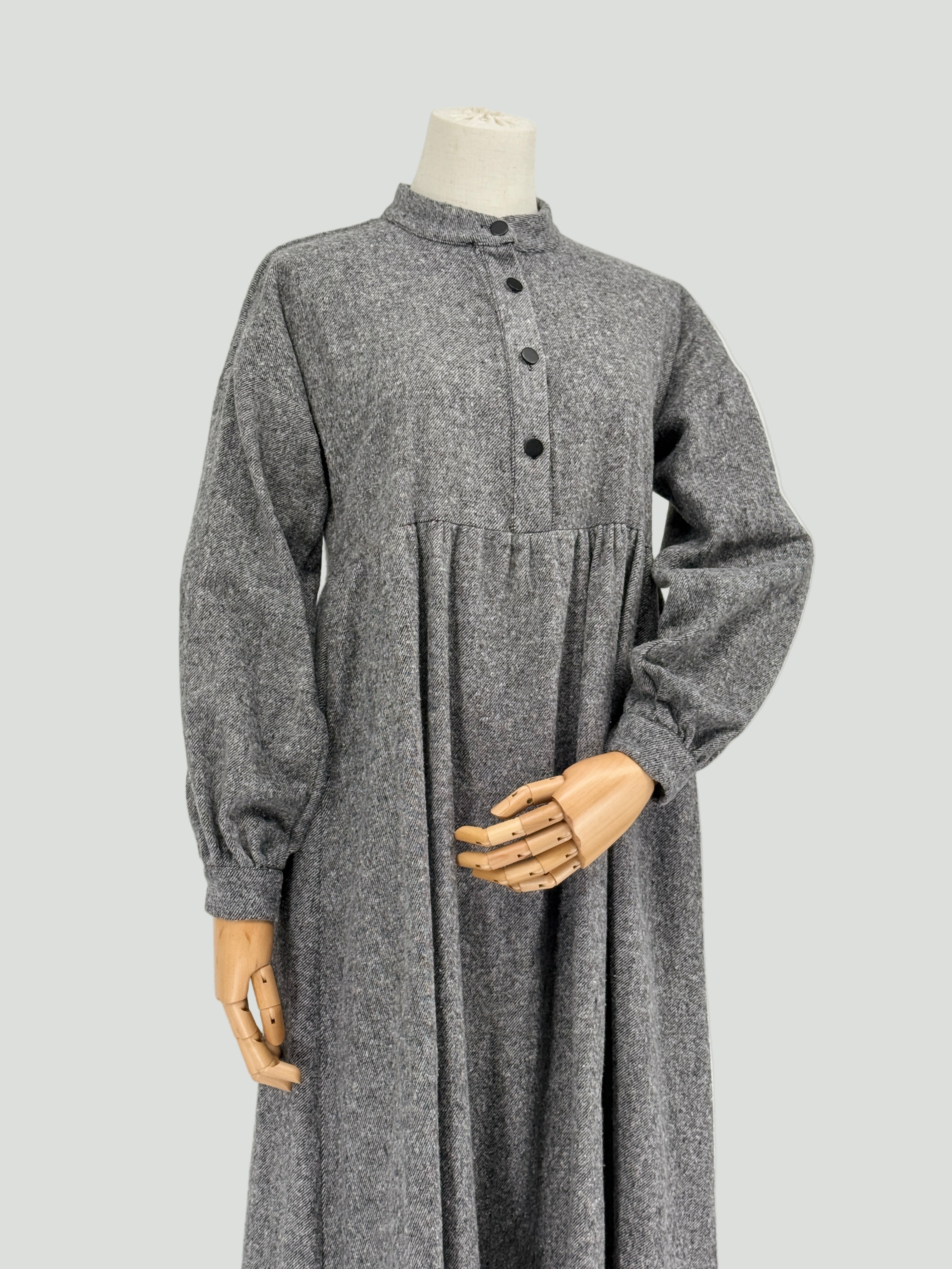 Gray long-sleeve dress on a mannequin against a white background