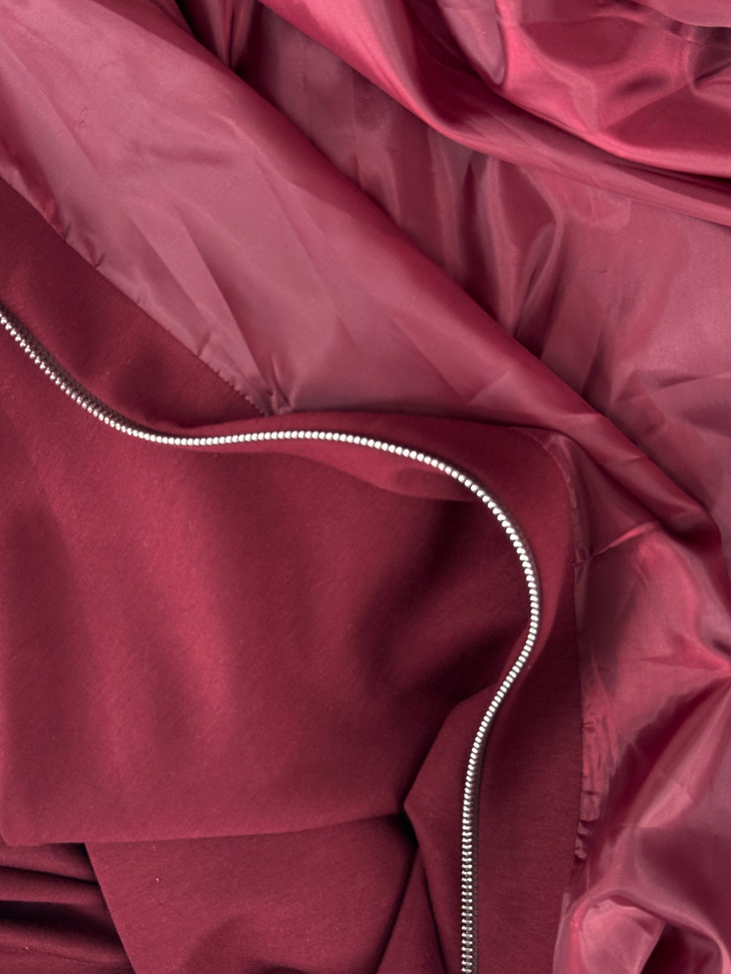 Close-up of a maroon fabric with a zipper