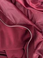 Close-up of a maroon fabric with a zipper
