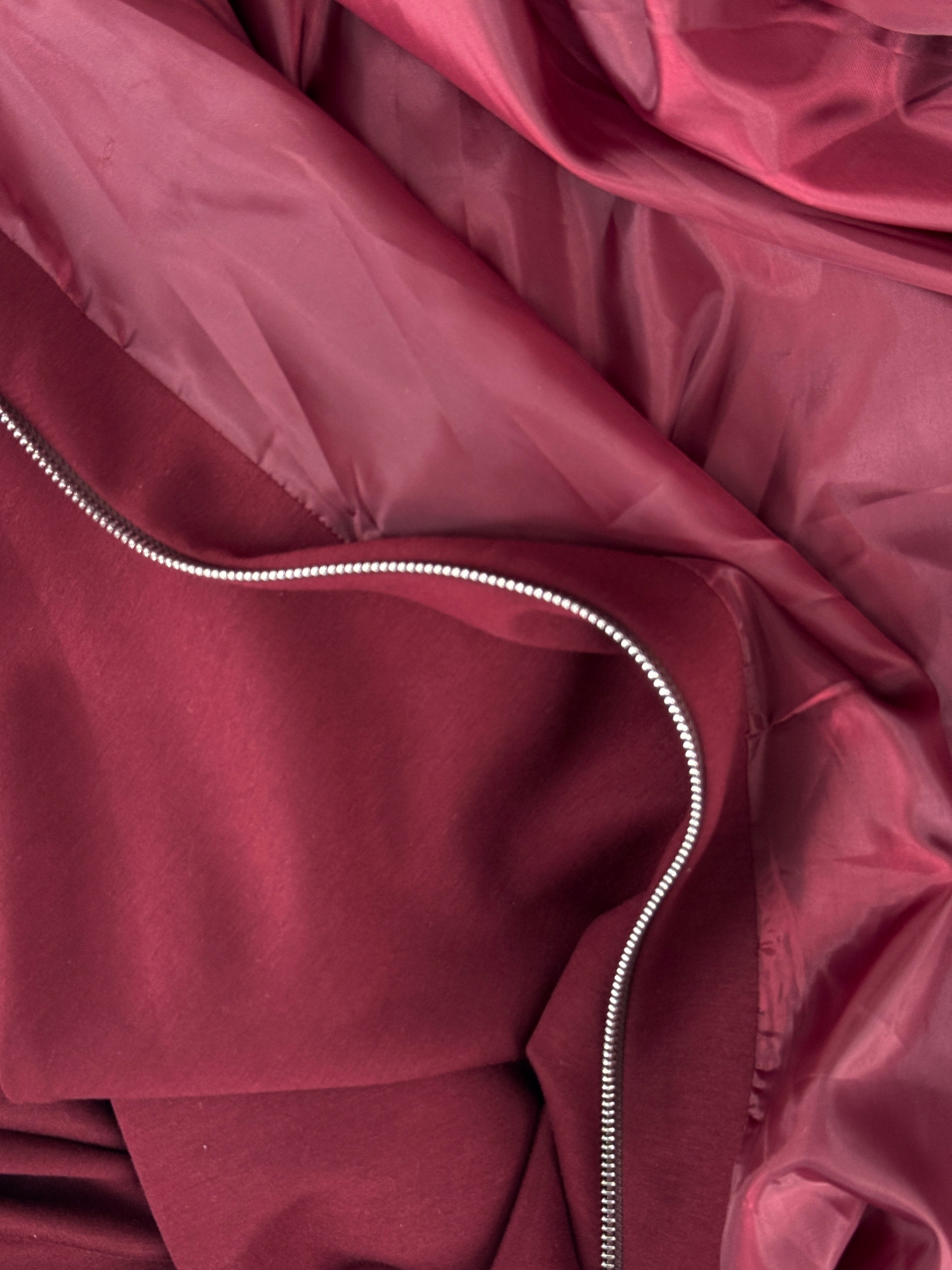 Close-up of a maroon fabric with a zipper