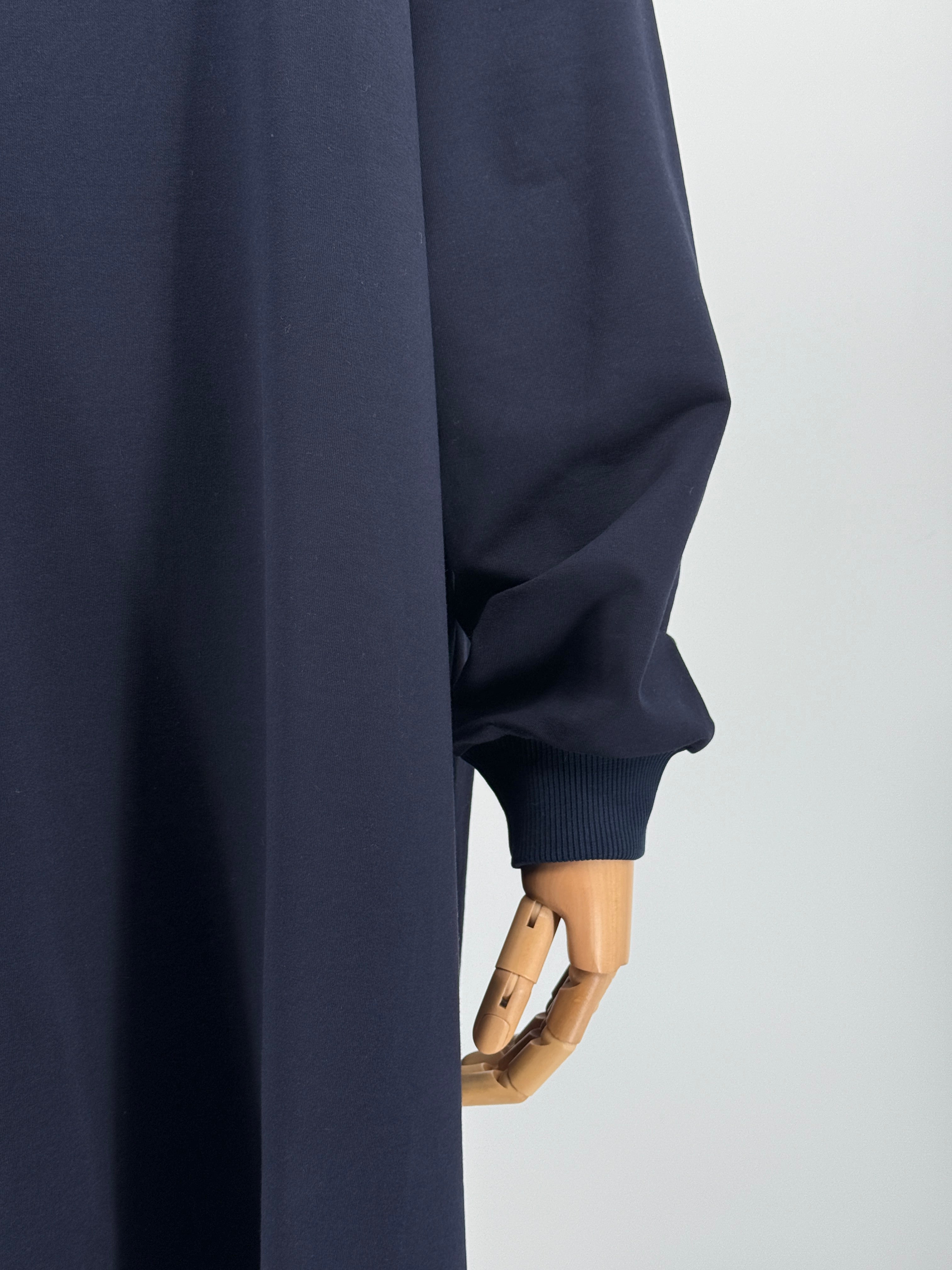 close-up of a navy blue long-sleeve tunic on a mannequin against a white background